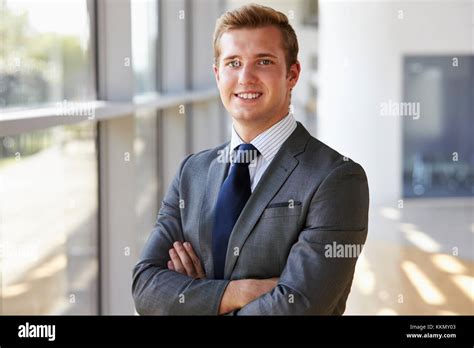 Portrait Of A Young Smiling Professional Man Arms Crossed Stock Photo