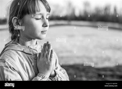 Young Girl Praying On The Background Of Nature Stock Photo Alamy