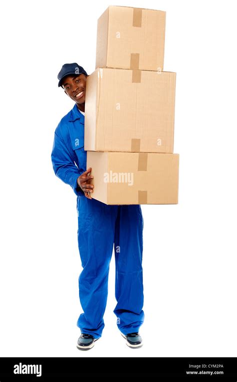 Full Length Portrait Of A Delivery Boy Carrying Heavy Boxes Isolated On