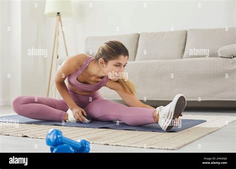 Woman With High Body Flexibility Stretching Her Leg To Warm Up Doing Aerobics Gymnastics