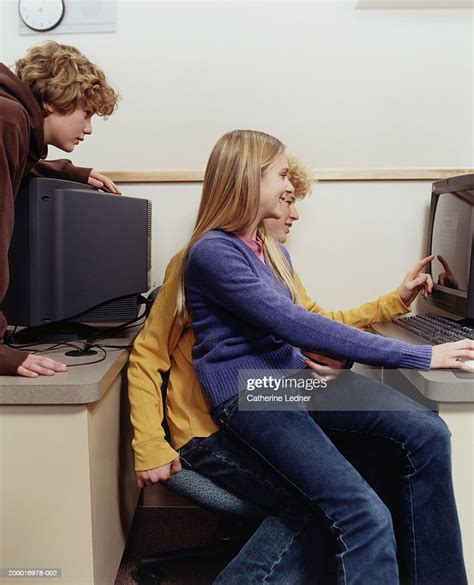 Teenage Girl Sitting On Boys Lap In Computer Class Photo Getty Images