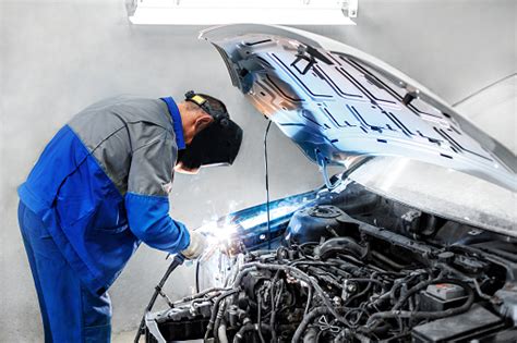 Professional Repairman Worker In Automotive Industry Welding Metal Body