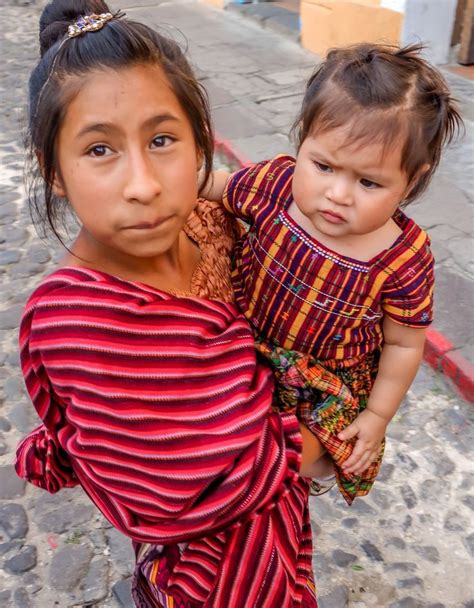 Guatemalan Girl Taking Care Of Her Sister Antigua Guatemal Travel Experts Travel Tips