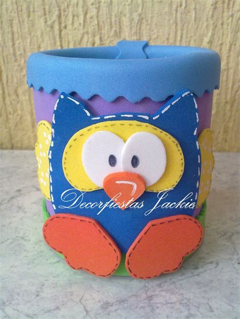 A Blue And Yellow Cup With A Bird On It S Face Sitting On A Counter