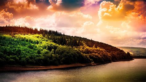Landscape View Of Trees Forest Slope Mountains Under Colorful Clouds