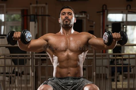 Bodybuilder Doing Heavy Weight Exercise For Shoulders Stock Photo