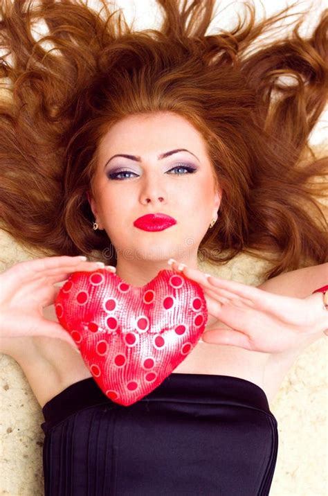Portrait Of A Fashionable Red Haired Model With Red Lips Lying Close