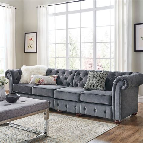 A white fireplace and ceiling beams balance dark walnut floors. Our Best Living Room Furniture Deals | Velvet sofa living ...