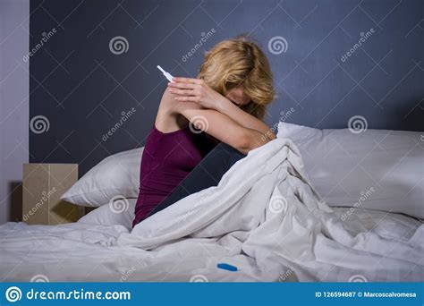 Lifestyle Portrait Of Young Desperate Pregnant Woman Using Pregnancy Test Sad And Depressed For