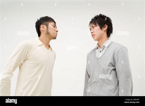 Two Young Men Glaring At Each Other Stock Photo Alamy