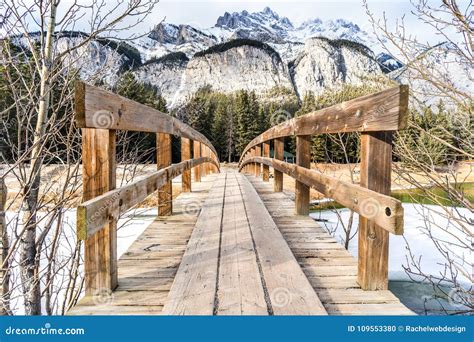 Wooden Foot Bridge Leading Over Glacial Stream To Inspiring Winter
