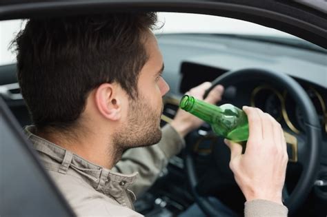 Premium Photo Man Drinking Beer While Driving