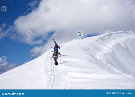 Skiers Climbing A Snowy Mountain Stock Photo Image Of Activity