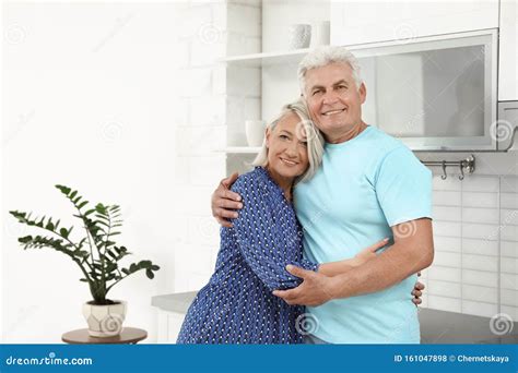 Portrait Of Affectionate Senior Couple In Kitchen Stock Photo Image