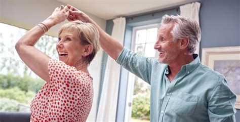 romantic senior retired couple dancing in lounge at home together stock image image of loving