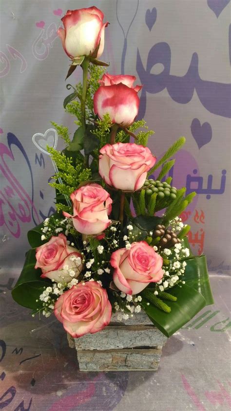 The Shape Of The Arrangement Is Is Triangular The Fill Flowers Are