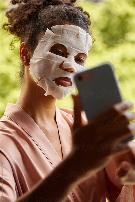 Woman With Beauty Face Mask Taking A Selfie By Stocksy Contributor Ohlamour Studio Stocksy