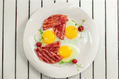 Fried Eggs With Bacon Bacon On A White Plate Breakfast Stock Image