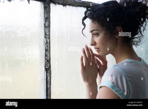 Sad Young Woman Looking Out Of The Window Stock Photo Alamy