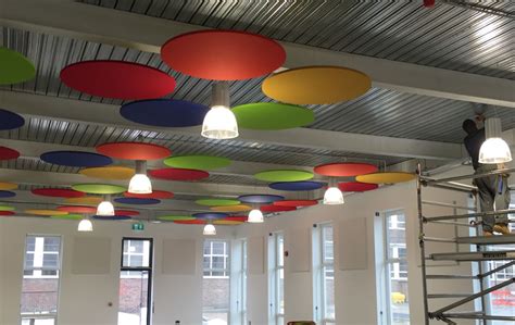 Suspended ceiling tiles serve many purposes including enclosing ductwork, hiding wiring, and lowering the height of the ceiling for energy conservation. Suspended Acoustic Ceiling Panels In Open Office