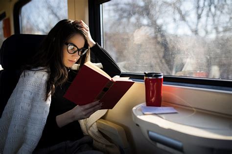 Woman Reading While Traveling With The Train Commuter Journey Sitting