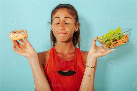 Woman Thinks To Eat Donuts Instead Of A Salad Stock Photo At Vecteezy