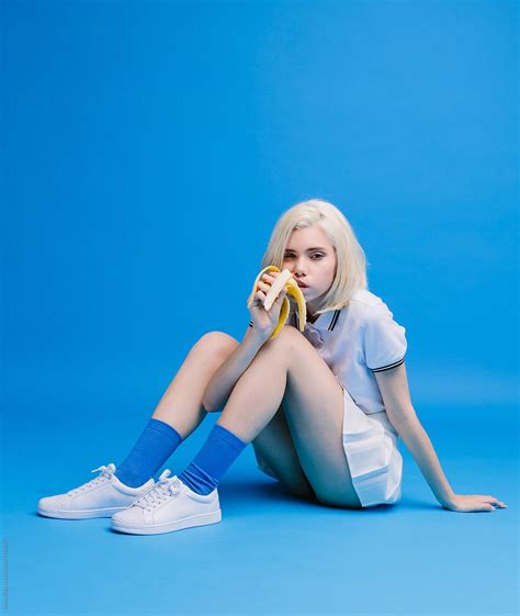 Blonde Girl Eating Banana Seductively By Javier Díez Stocksy United