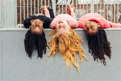 view upside down african american and caucasian girls by stocksy contributor gabriel gabi