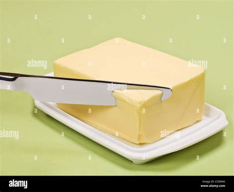 Ein Stück Butter Wird Angeschnitten A Piece Of Butter Is Sliced Stock