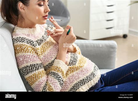Pregnant Woman Smoking Cigarette At Home Stock Photo Alamy