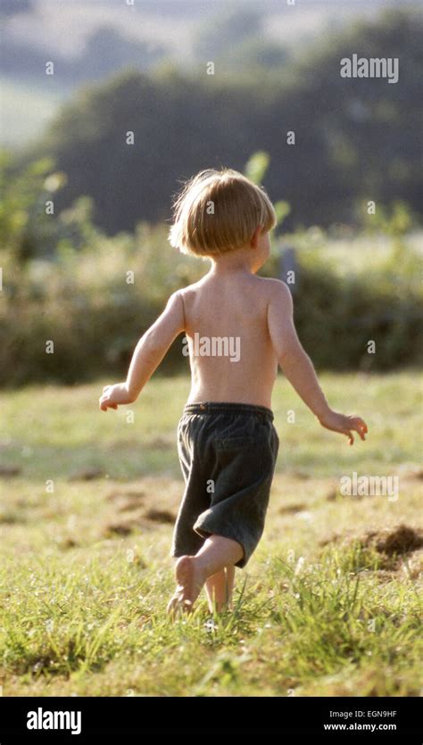 Young Active Happy Barefoot Boy Running Away In Sunny Natural Country