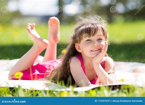 Beautiful Girl Lying On The Lawn In The Park Stock Photo Image Of