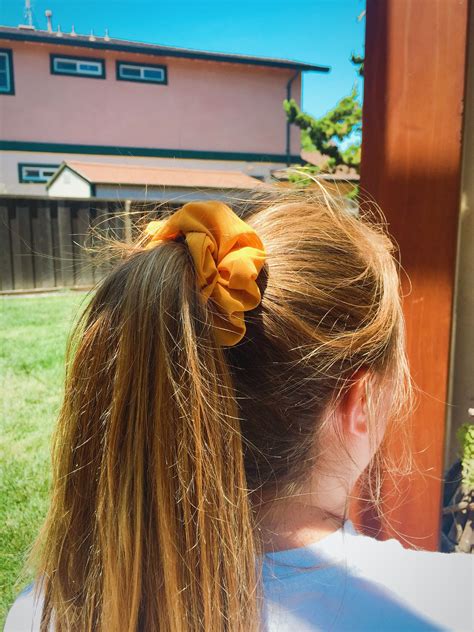 Trendy Summer Hairstyle High Ponytail With Yellow Scrunchie