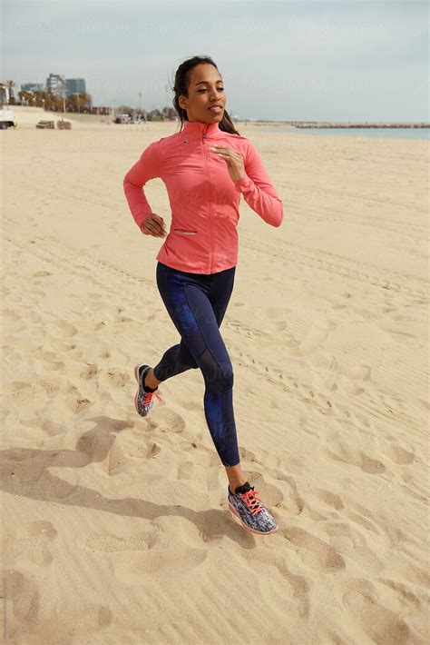 Determined Sportswoman Running On Beach By Stocksy Contributor Milles Studio Stocksy