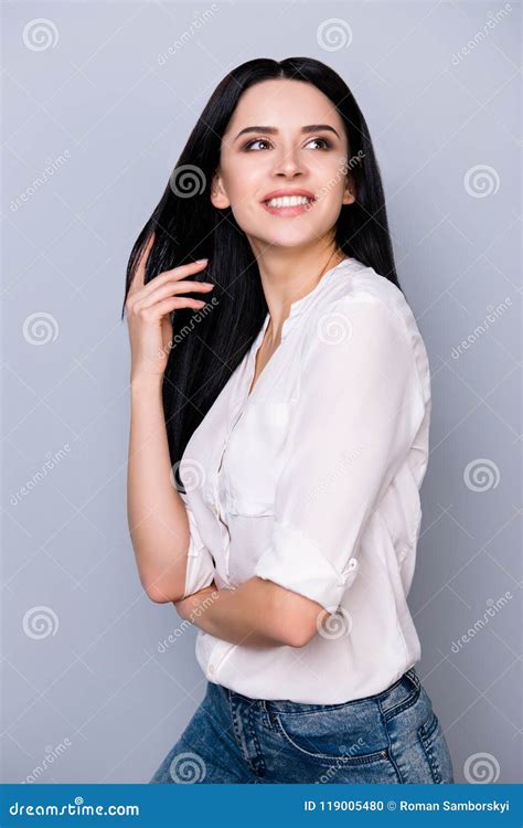 Dreamy Brunette In Casual Outfit Is Looking Away Dreamy And Touches Her