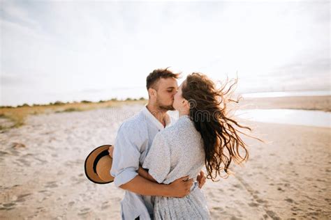 Young Couple Kissing On A Deserted Beach At Dawn Stock Image Image Of