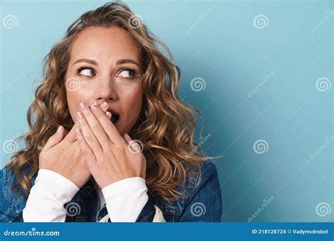 Blonde Shocked Woman Covering Her Mouth And Looking Aside Stock Photo