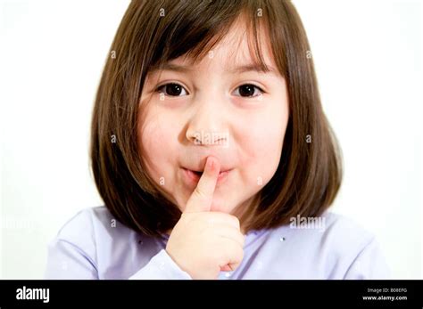Little Girl With Finger Over Her Mouth Stock Photo Alamy