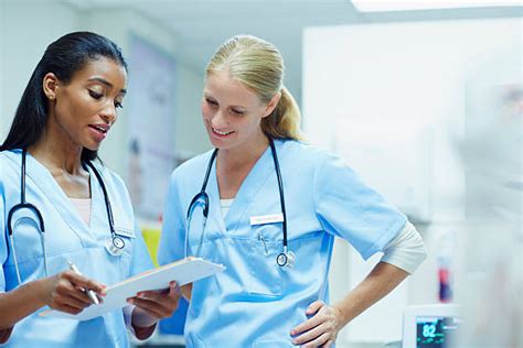 Two Nurses Working Together Stock Photos Pictures And Royalty Free