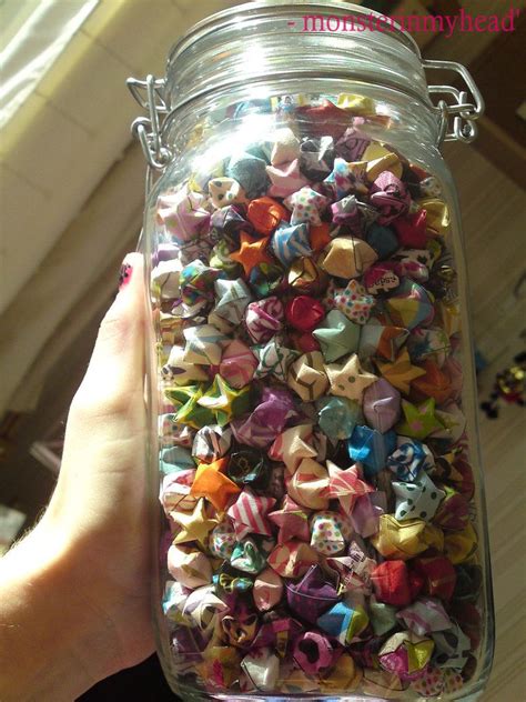 A Person Is Holding A Jar Full Of Small Bows