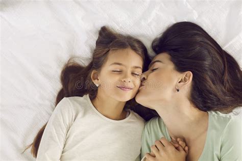 Feliz Madre Besa A Su Hija En La Mejilla Mientras La Despierta En La