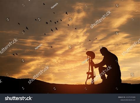 Silhouette Soldier Kneeling His Head Bowed Stock Photo 2157574389