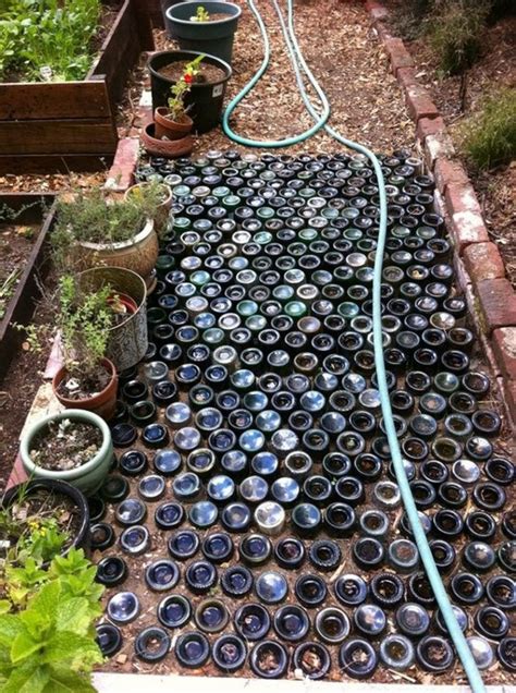 The Garden Is Filled With Pots And Hoses To Water Its Planters