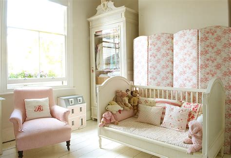 This girl's bedroom features a floral accent wall and touches of pink. 1 nursery girls bedroom 5