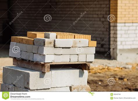 Stacks Of Silicate Bricks On Wooden Pallets And In Polyethylene Stock