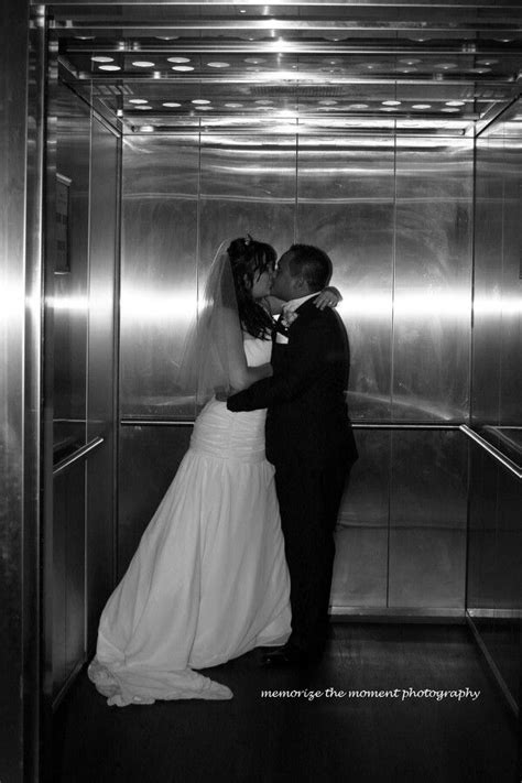 wedding photo in an elevator going up sneak a kiss in before the reception