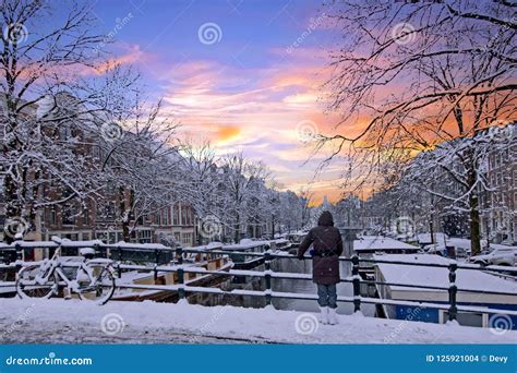 Amsterdam Covered With Snow In Winter In The Netherlands At Sun Stock