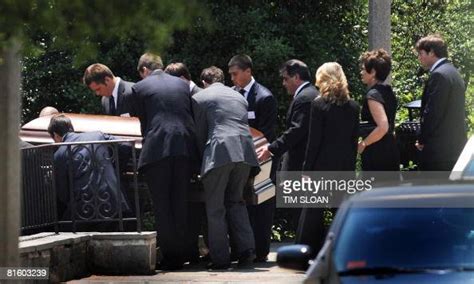 Pallbearers Carry The Casket Of Journalist Tim Russert Followed By