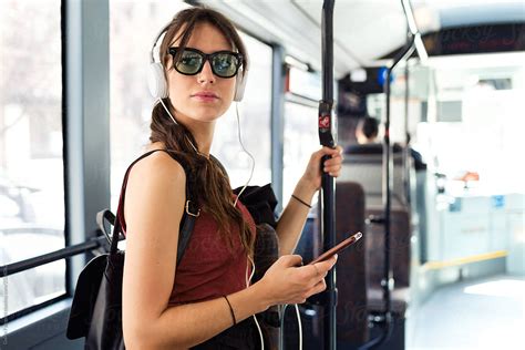Beautiful Woman With Phone In Bus By Stocksy Contributor Guille