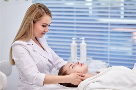 Young Woman Enjoying Anti Aging Facial Massage Pretty Lady Getting Professional Skin Care Stock